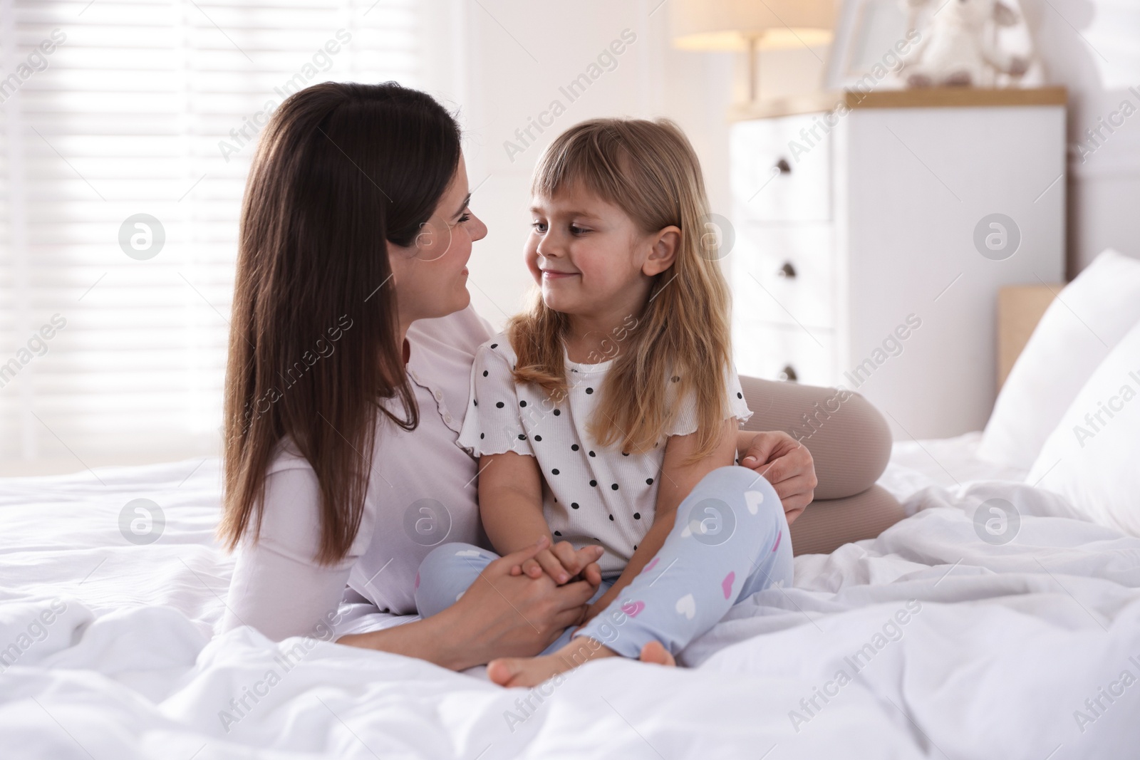 Mother and daughter on bed at home Photo of Mother and daughter on bed at home
