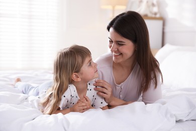 Photo of Mother and daughter on bed at home