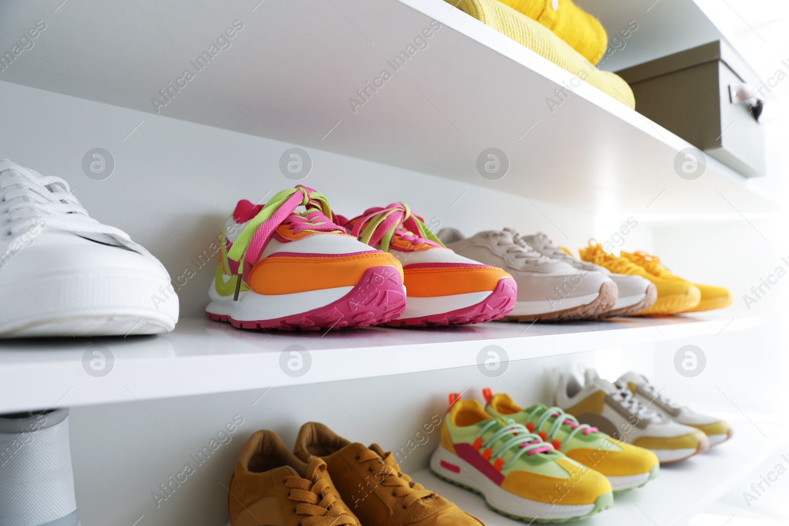 Different footwear on shelves indoors, closeup. Shoe storage Photo of Different footwear on shelves indoors, closeup. Shoe storage