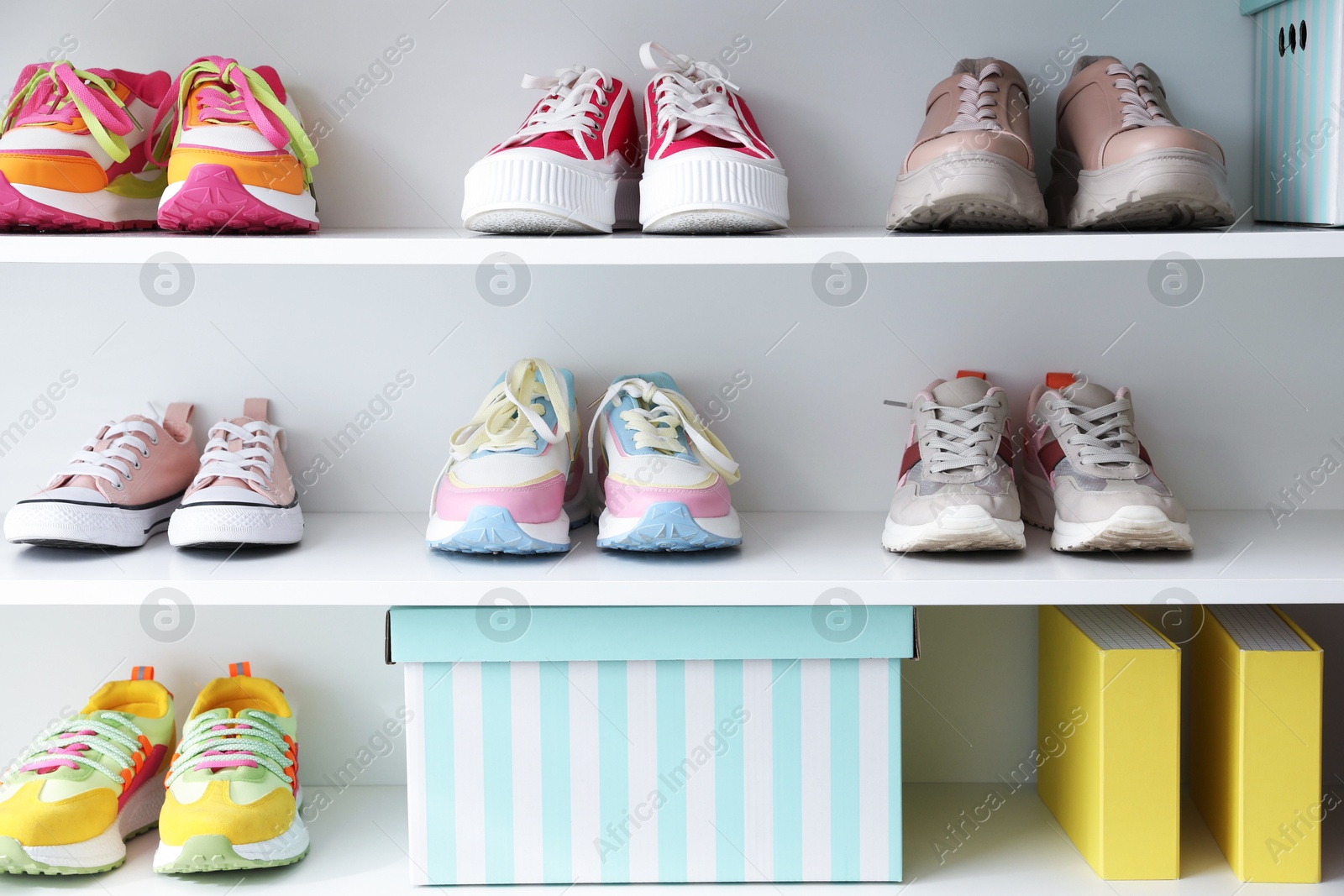 Different footwear on shelves indoors. Shoe storage Photo of Different footwear on shelves indoors. Shoe storage