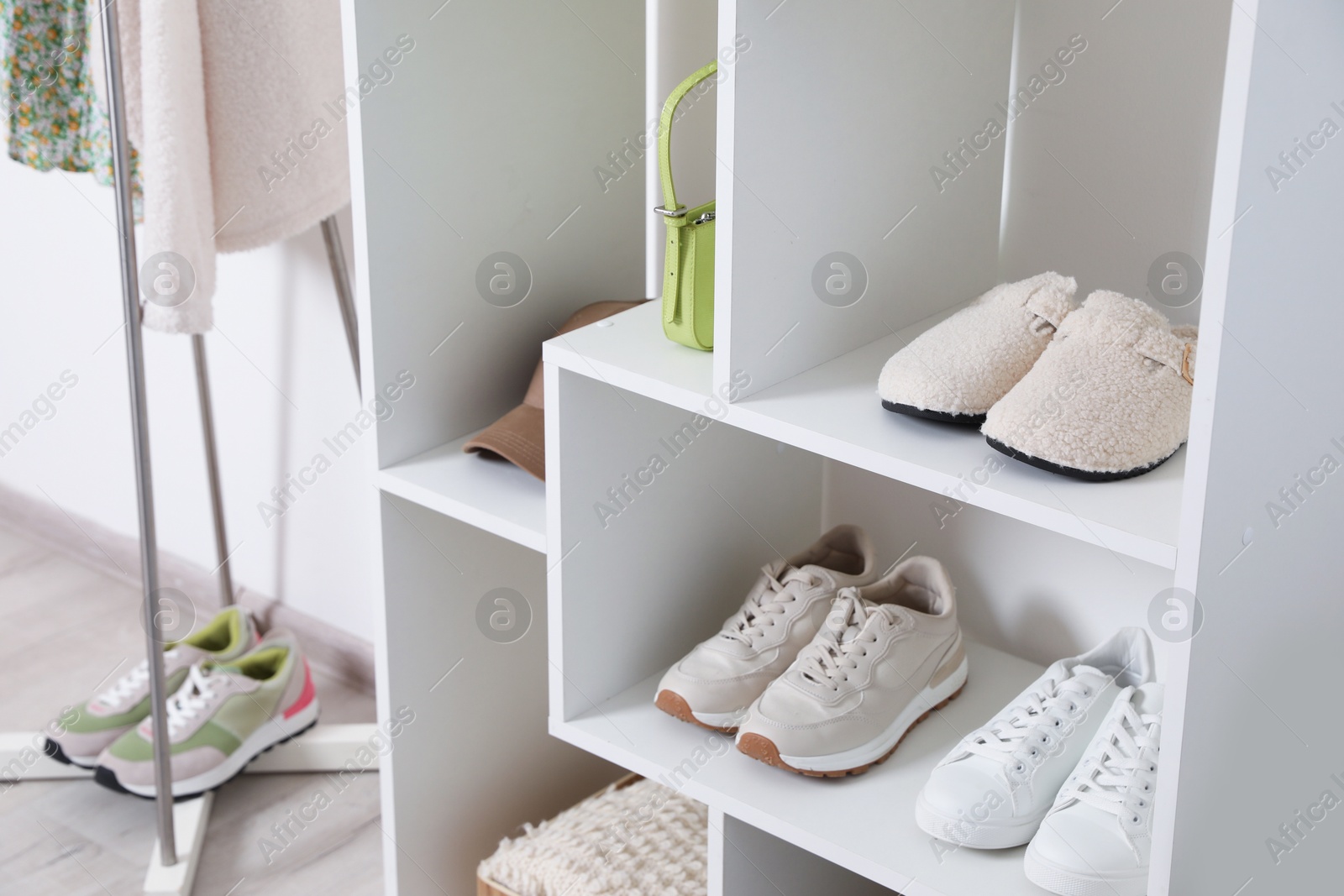 Shelving unit with different footwear and accessories indoors, closeup. Shoe storage Photo of Shelving unit with different footwear and accessories indoors, closeup. Shoe storage