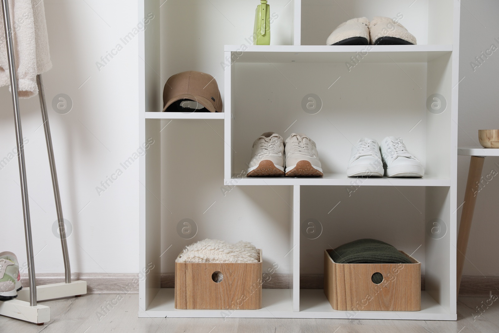 Shelving unit with different footwear, clothes and accessories indoors. Shoe storage Photo of Shelving unit with different footwear, clothes and accessories indoors. Shoe storage