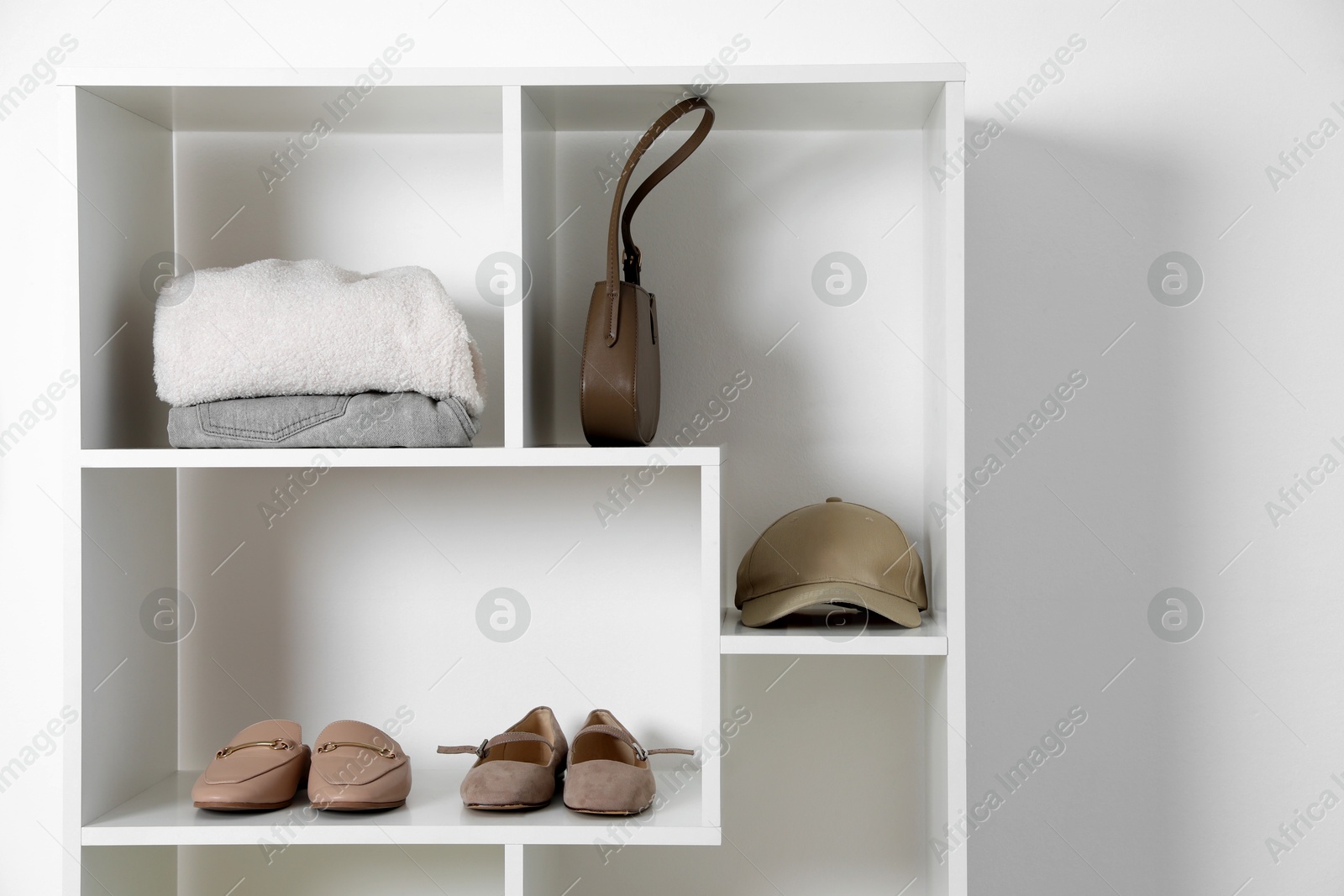 Shelving unit with different footwear and accessories indoors. Shoe storage Photo of Shelving unit with different footwear and accessories indoors. Shoe storage