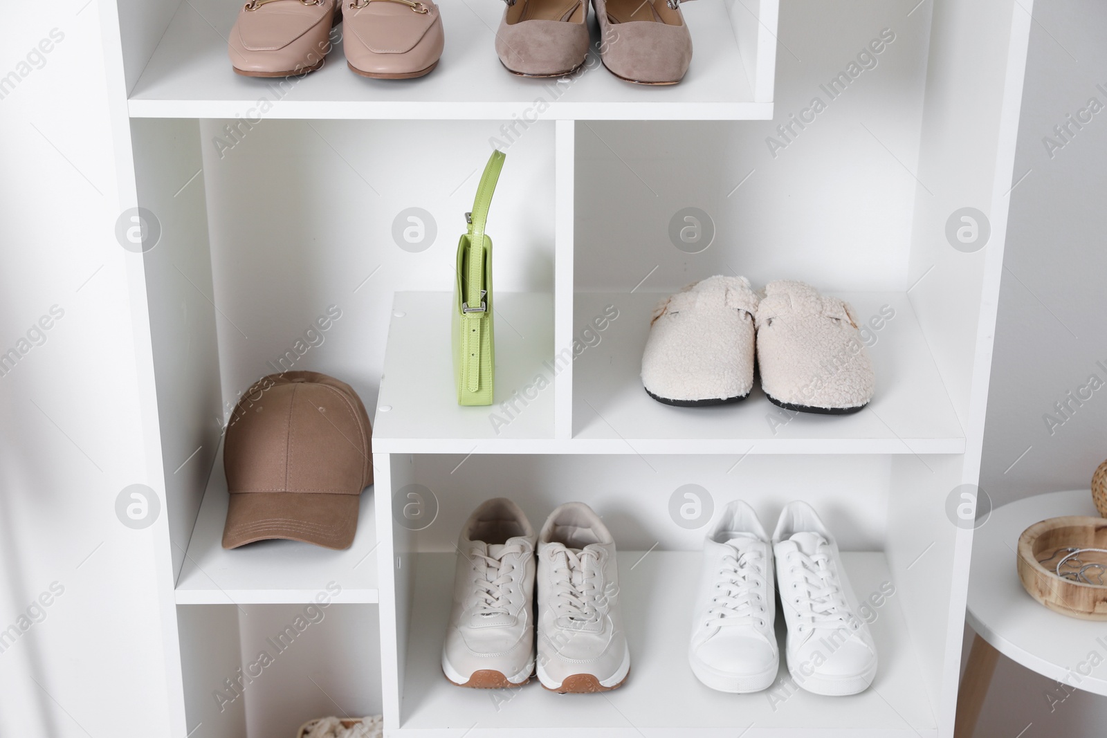 Shelving unit with different footwear and accessories indoors. Shoe storage Photo of Shelving unit with different footwear and accessories indoors. Shoe storage