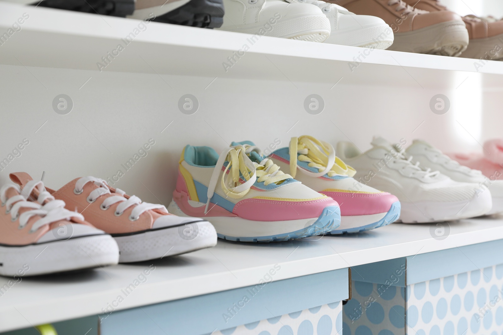 Different footwear on shelves indoors, closeup. Shoe storage Photo of Different footwear on shelves indoors, closeup. Shoe storage