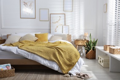 Photo of Comfortable bed with soft linens in stylish room. Home textile