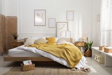Photo of Comfortable bed with soft linens in stylish room. Home textile