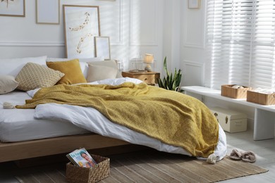 Photo of Comfortable bed with soft linens in stylish room. Home textile