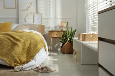 Photo of Comfortable bed with soft linens in stylish room. Home textile