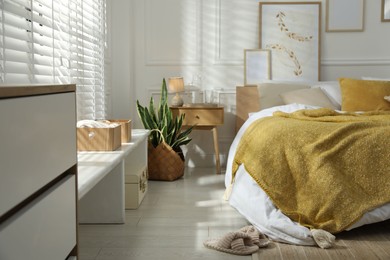 Photo of Comfortable bed with soft linens in stylish room. Home textile