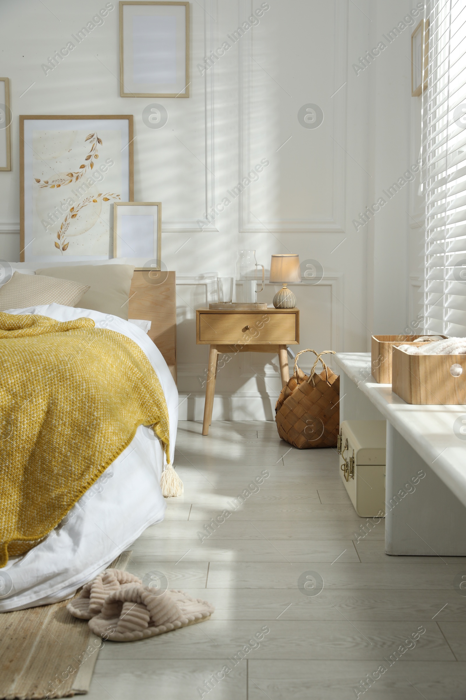 Comfortable bed with soft linens in stylish room. Home textile Photo of Comfortable bed with soft linens in stylish room. Home textile