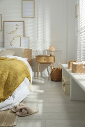 Photo of Comfortable bed with soft linens in stylish room. Home textile