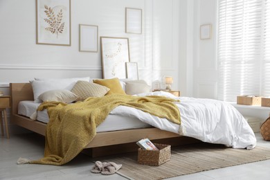 Photo of Comfortable bed with soft linens in stylish room. Home textile