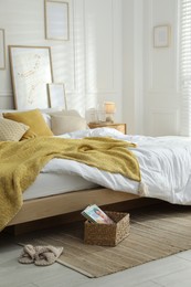 Photo of Comfortable bed with soft linens in stylish room. Home textile
