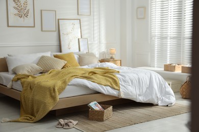 Photo of Comfortable bed with soft linens in stylish room. Home textile