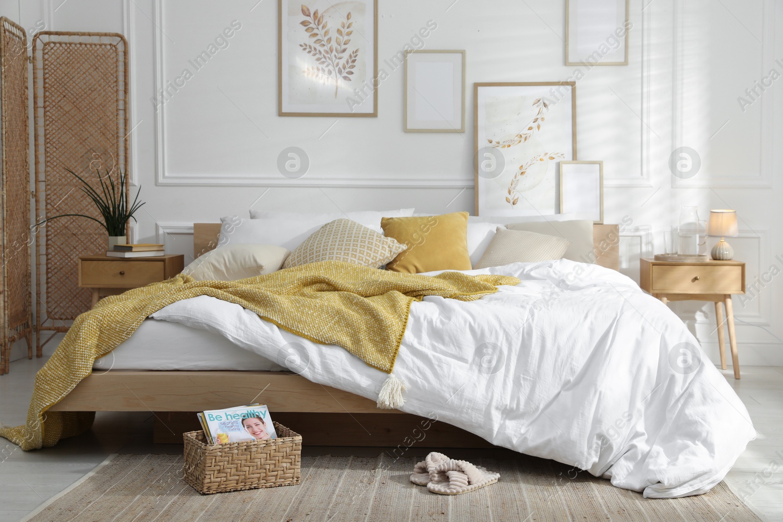 Comfortable bed with soft linens in stylish room. Home textile Photo of Comfortable bed with soft linens in stylish room. Home textile