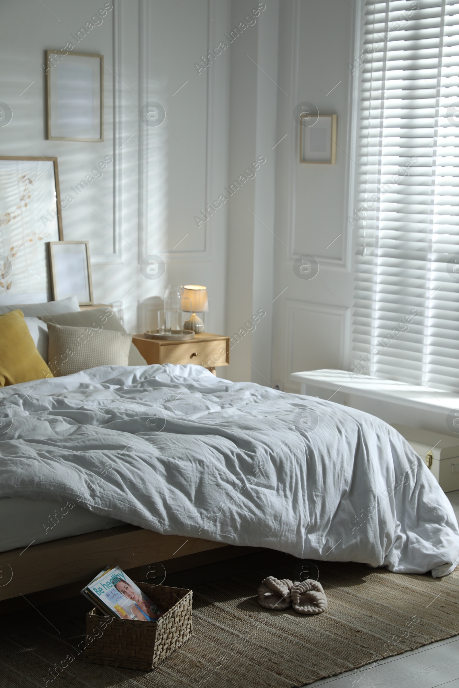 Comfortable bed with soft linens in stylish room. Home textile Photo of Comfortable bed with soft linens in stylish room. Home textile