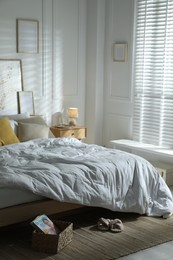 Photo of Comfortable bed with soft linens in stylish room. Home textile