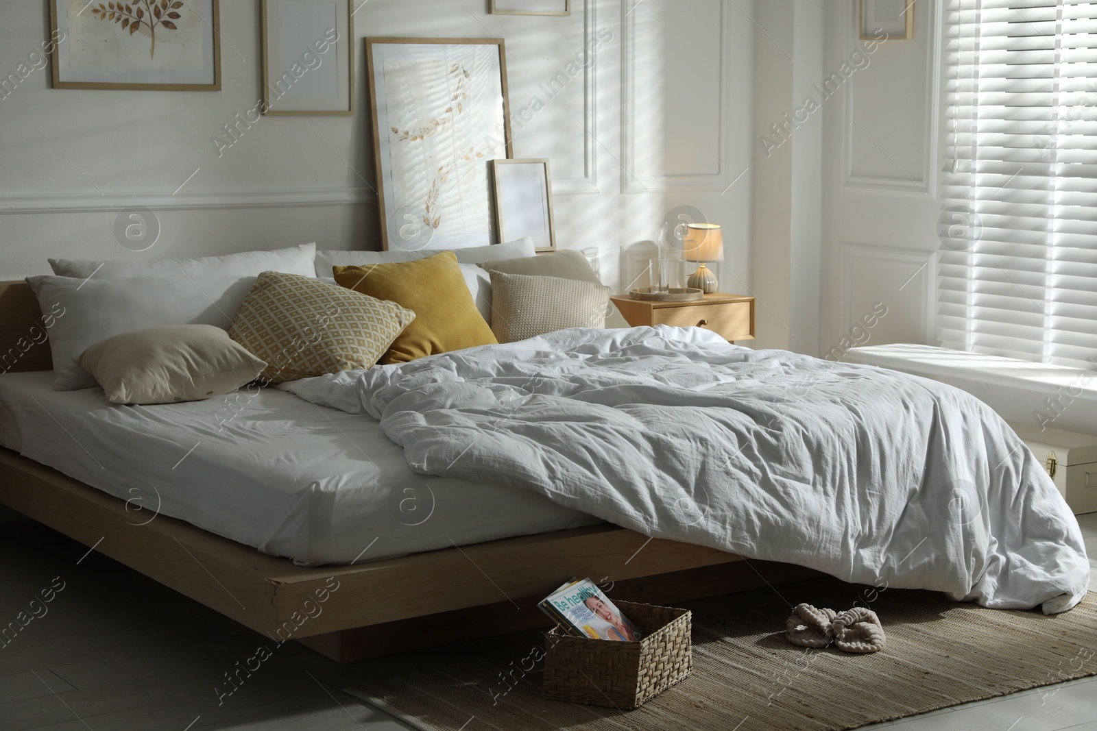 Comfortable bed with soft linens in stylish room. Home textile Photo of Comfortable bed with soft linens in stylish room. Home textile