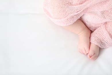 Photo of Little baby lying on bed indoors, top view. Space for text