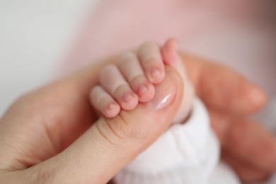 Photo of Mother with her little baby on bed indoors, closeup