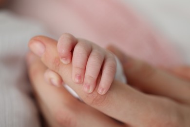 Photo of Mother with her little baby on bed indoors, closeup