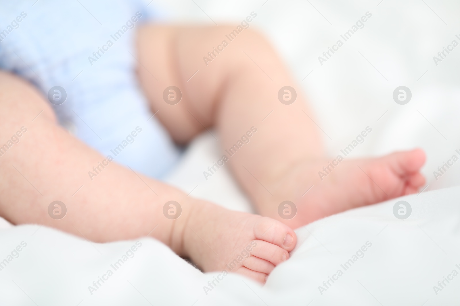 Little baby lying on bed indoors, closeup Photo of Little baby lying on bed indoors, closeup