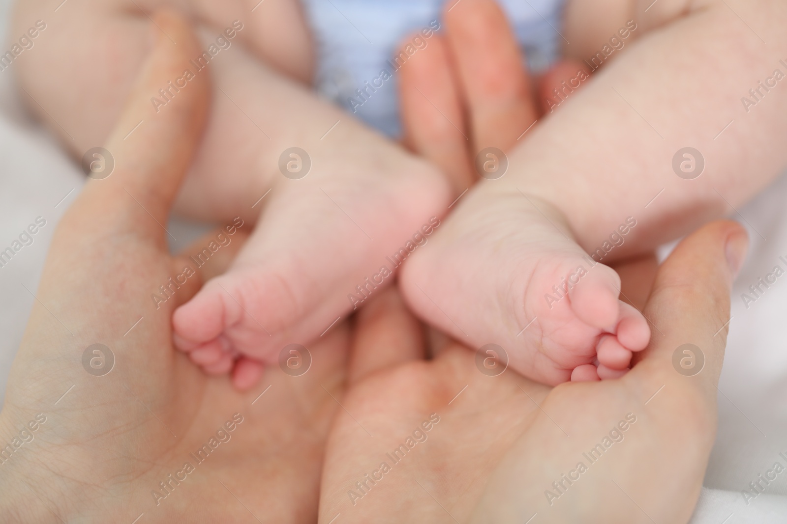 Mother with her little baby on bed indoors, closeup Photo of Mother with her little baby on bed indoors, closeup