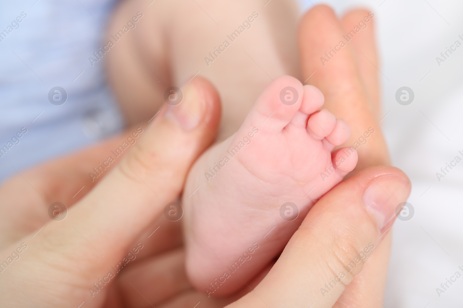 Mother with her little baby on bed indoors, closeup Photo of Mother with her little baby on bed indoors, closeup