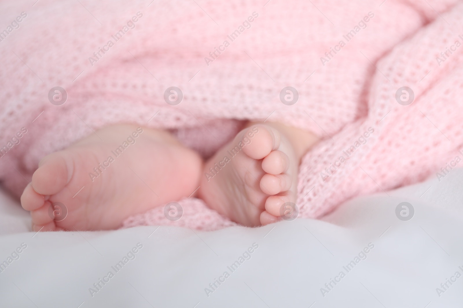 Little baby lying on bed indoors, closeup Photo of Little baby lying on bed indoors, closeup