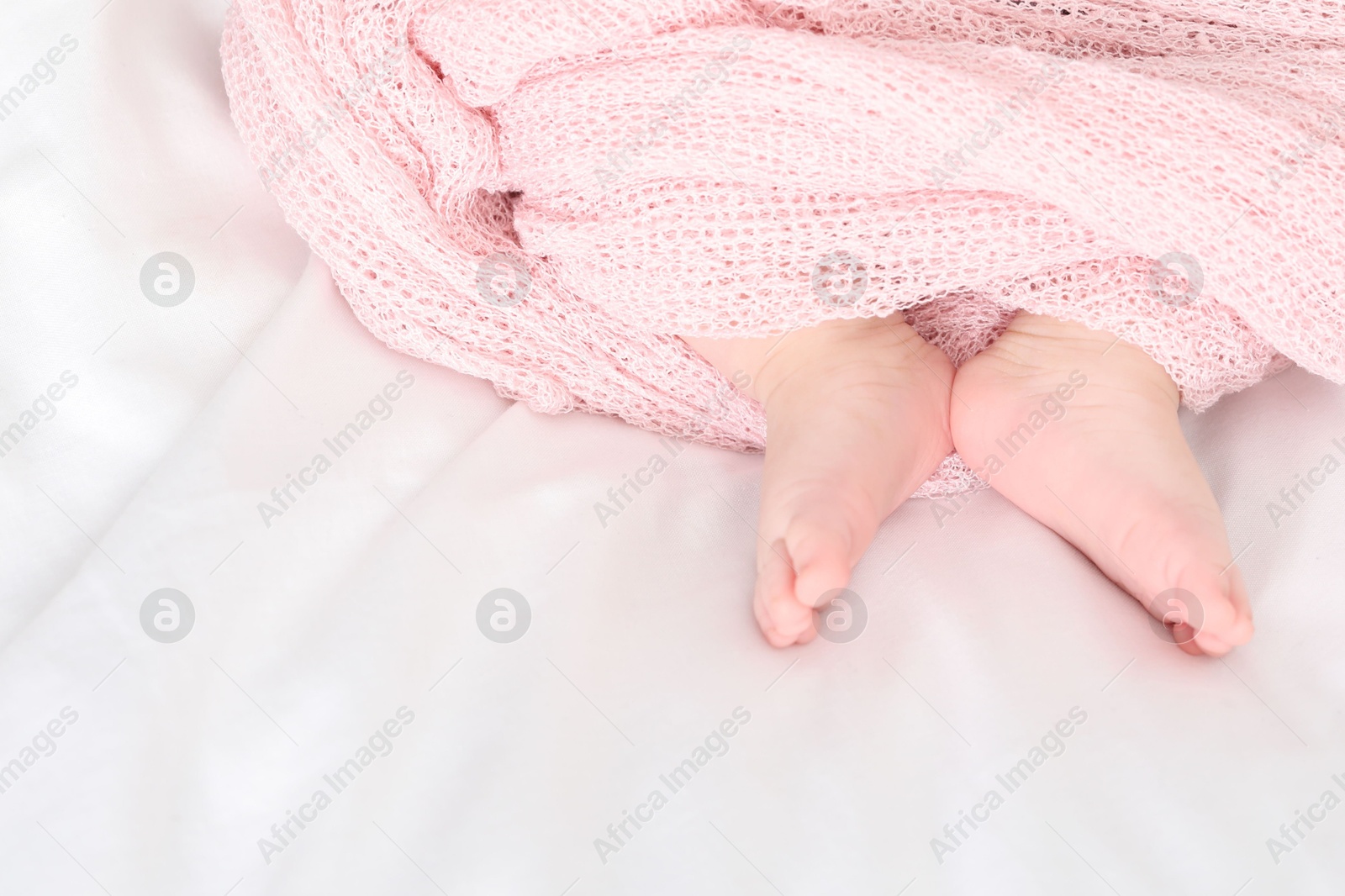 Little baby lying on bed indoors, top view. Space for text Photo of Little baby lying on bed indoors, top view. Space for text