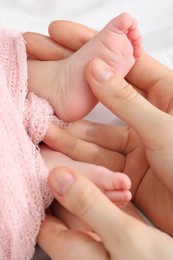 Photo of Mother with her little baby on bed indoors, top view