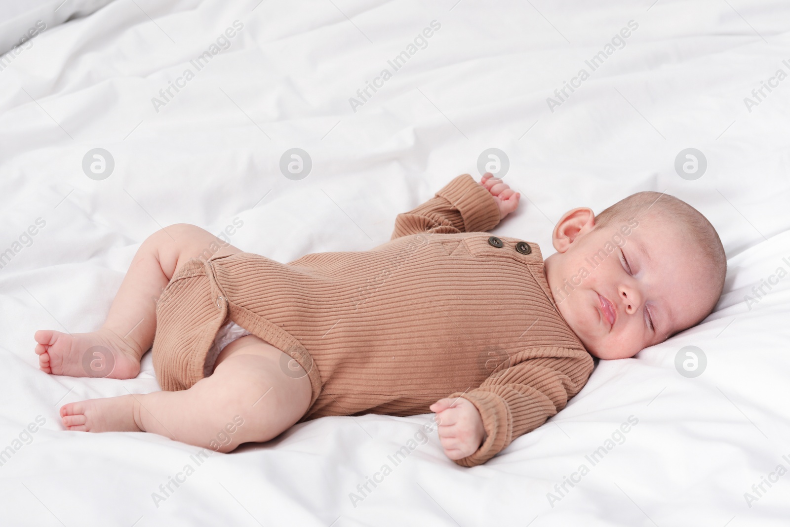 Cute little baby sleeping on bed indoors Photo of Cute little baby sleeping on bed indoors