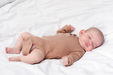 Photo of Cute little baby sleeping on bed indoors