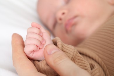 Photo of Mother with her little baby on bed indoors, closeup