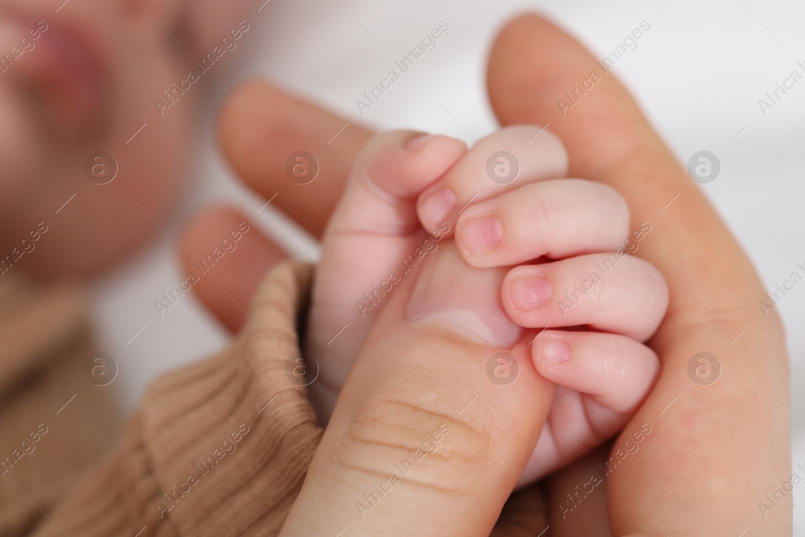 Mother with her little baby on bed indoors, closeup Photo of Mother with her little baby on bed indoors, closeup