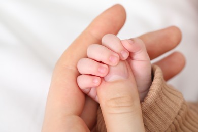 Photo of Mother with her little baby on bed indoors, closeup