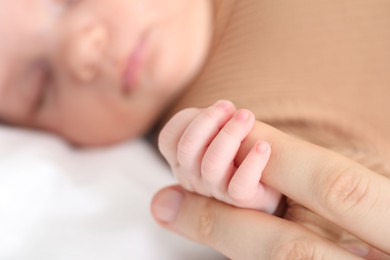Photo of Mother with her little baby on bed indoors, closeup