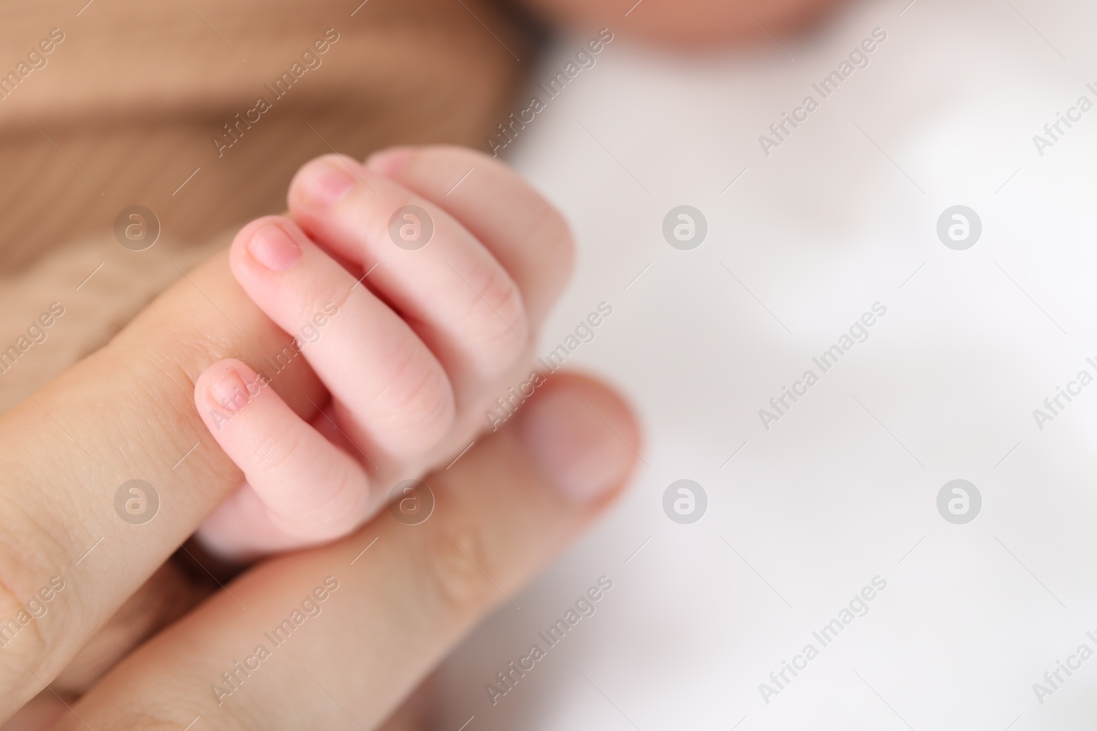 Mother with her little baby on bed indoors, closeup. Space for text Photo of Mother with her little baby on bed indoors, closeup. Space for text