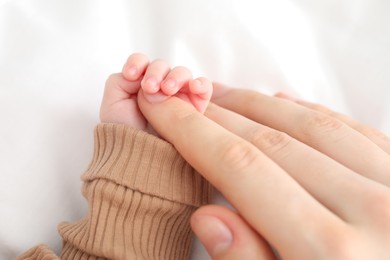 Photo of Mother with her little baby on bed indoors, closeup