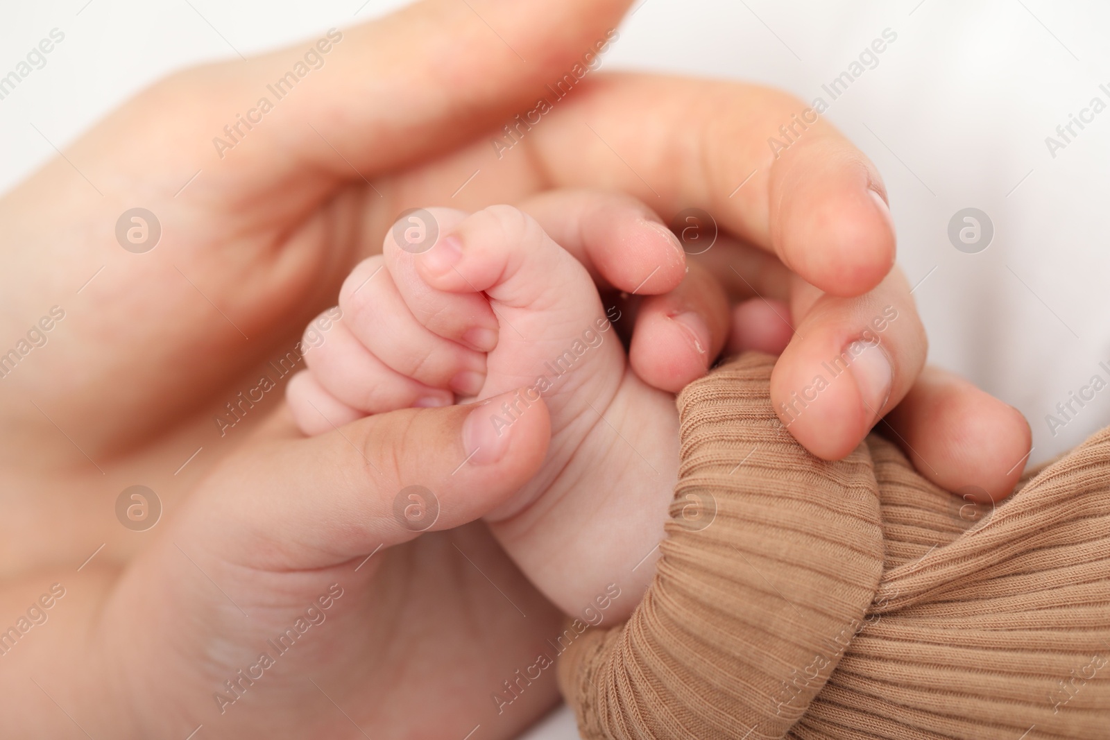 Mother with her little baby on bed indoors, closeup Photo of Mother with her little baby on bed indoors, closeup