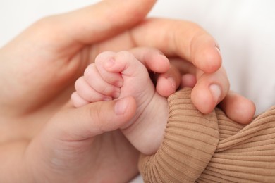 Photo of Mother with her little baby on bed indoors, closeup