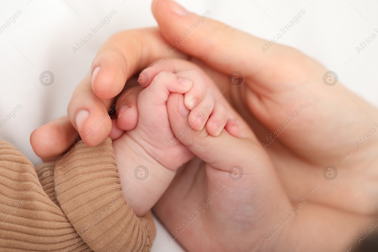 Mother with her little baby on bed indoors, closeup Photo of Mother with her little baby on bed indoors, closeup