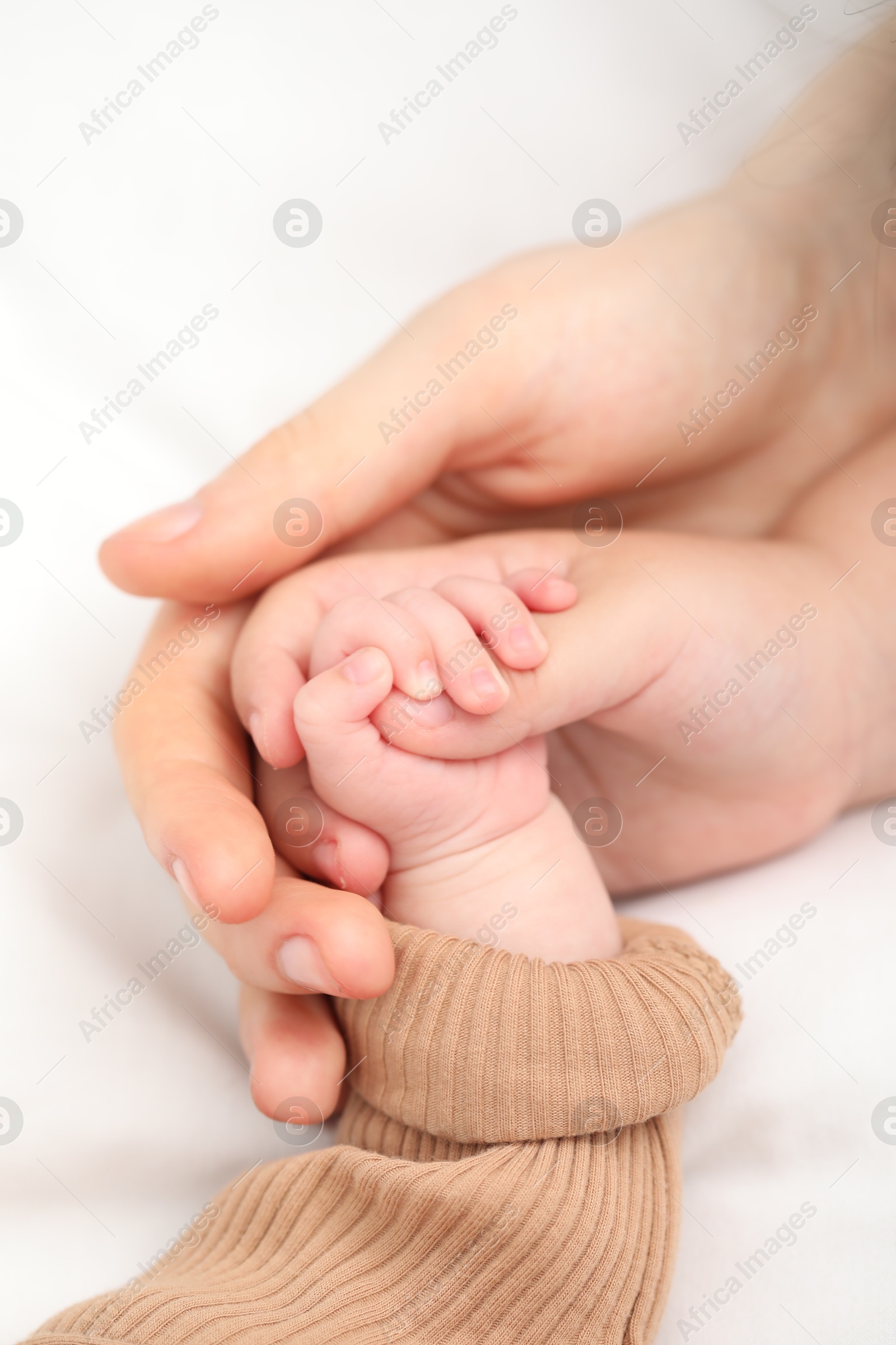 Mother with her little baby on bed indoors, closeup Photo of Mother with her little baby on bed indoors, closeup