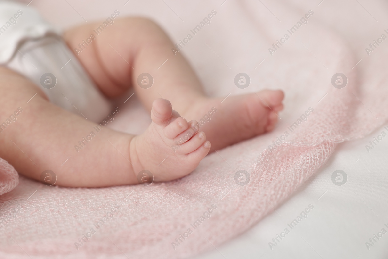 Cute little baby lying on bed at home, closeup Photo of Cute little baby lying on bed at home, closeup