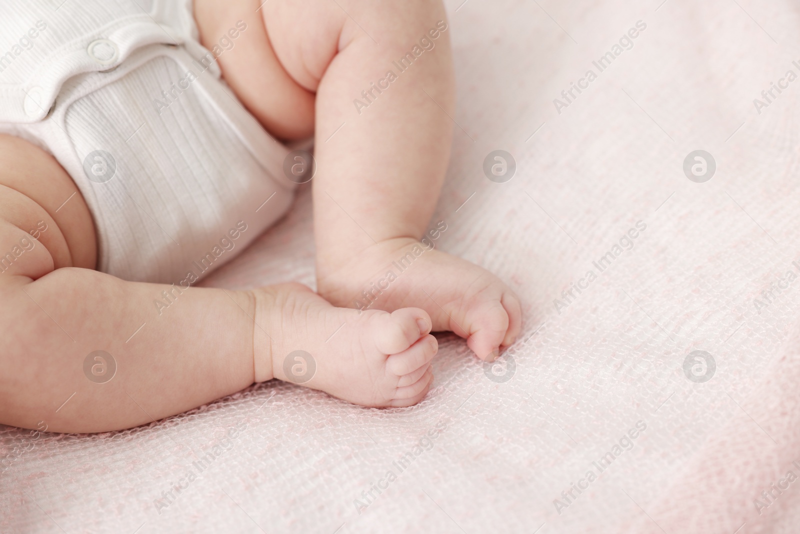 Cute little baby lying on bed at home, closeup. Space for text Photo of Cute little baby lying on bed at home, closeup. Space for text