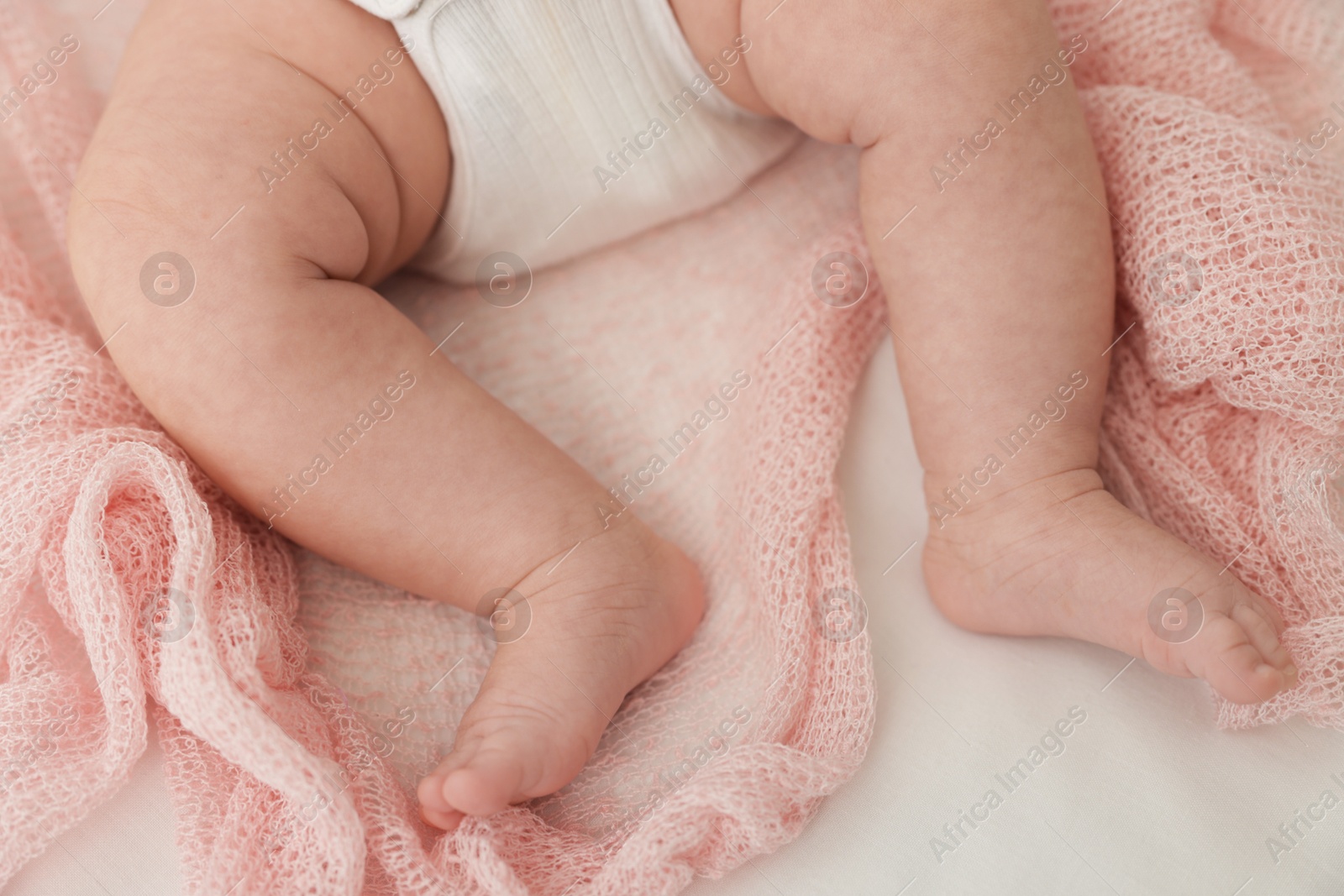 Cute little baby lying on bed at home, top view Photo of Cute little baby lying on bed at home, top view