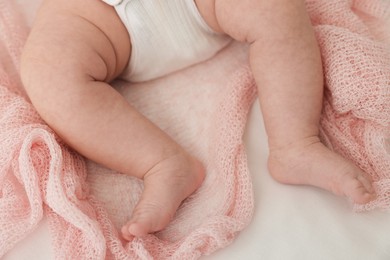 Photo of Cute little baby lying on bed at home, top view