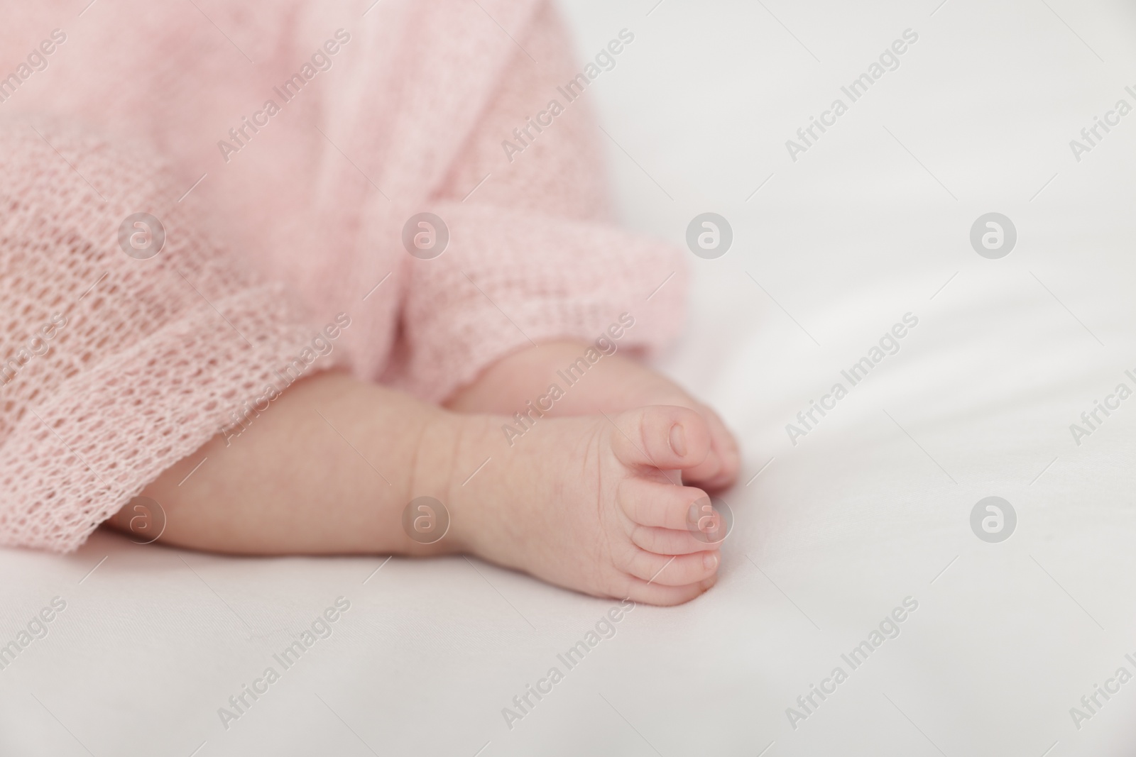 Cute little baby lying on bed at home, closeup. Space for text Photo of Cute little baby lying on bed at home, closeup. Space for text
