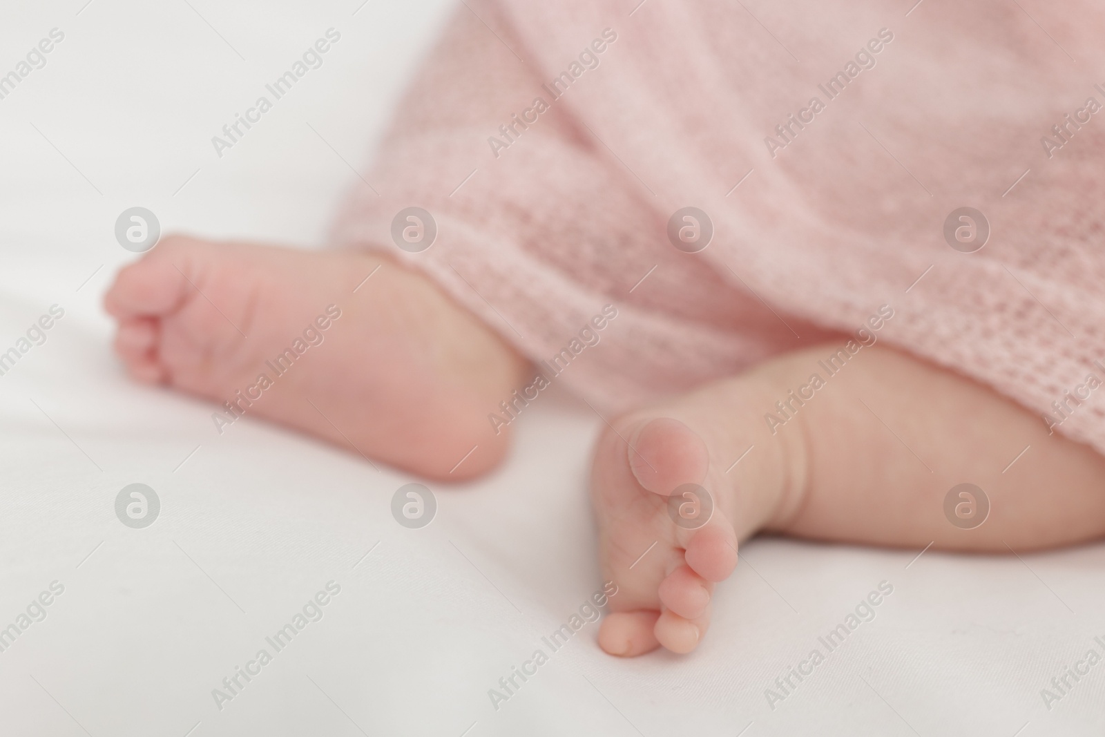 Cute little baby lying on bed at home, closeup Photo of Cute little baby lying on bed at home, closeup